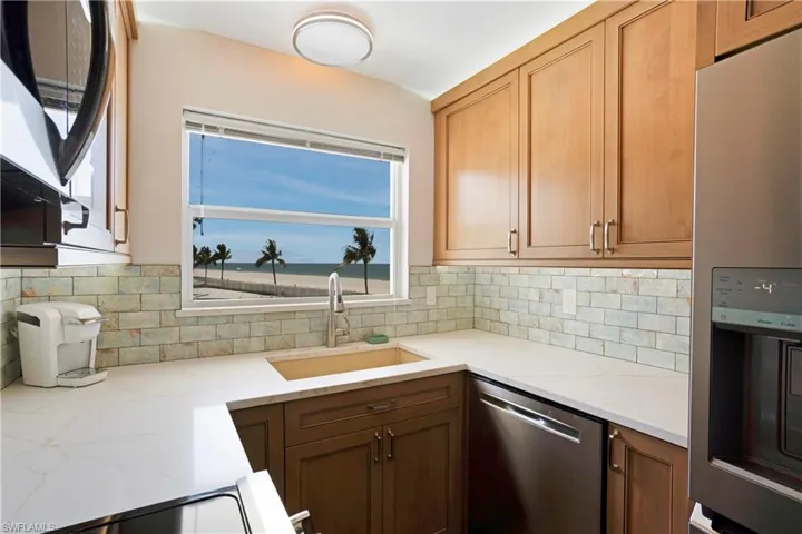 Large farm style sink, lighting above the cabinets, and Gulf views out the kitchen window!