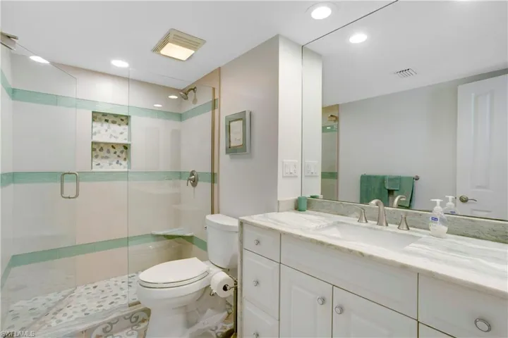 Primary Bathroom -new renovation, custom tile, quartz waterfall counter.