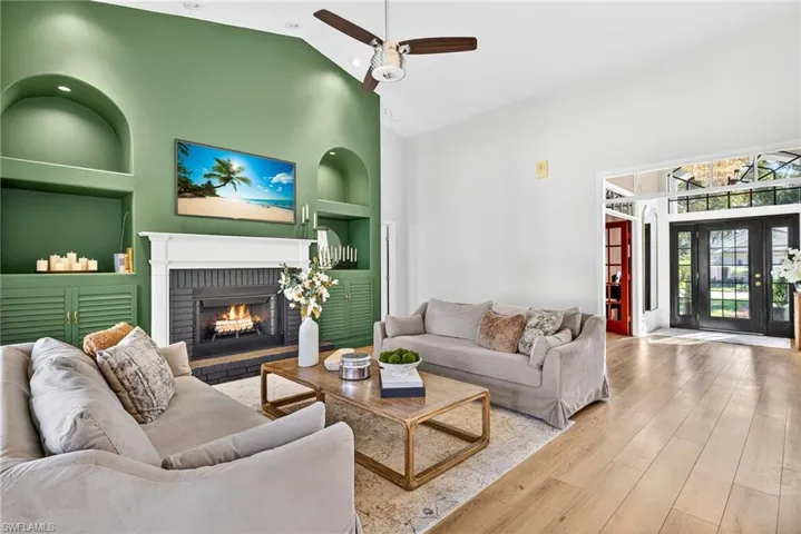 Living area featuring built ins and wood burning fire place