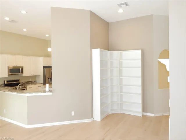 Light wood-finish flooring with recessed lighting