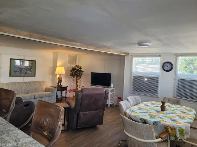 Living room with dark wood-type flooring