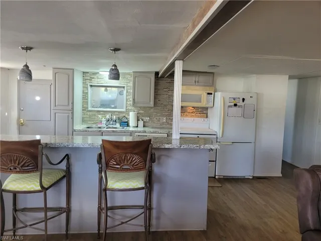 kitchen island, Hall to bedroom and bath on the right