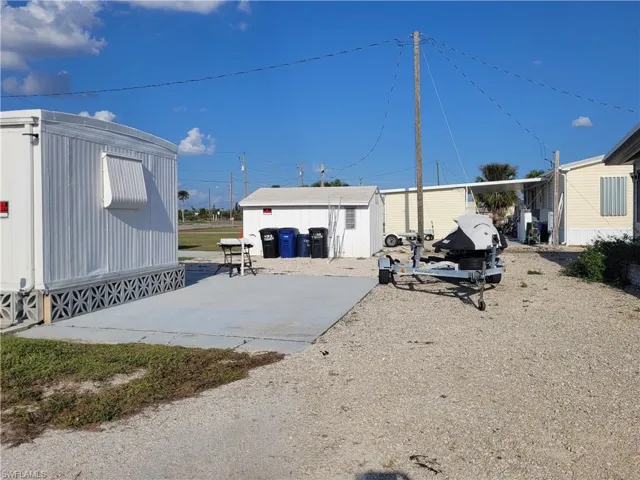 Back of property with a patio and a shed