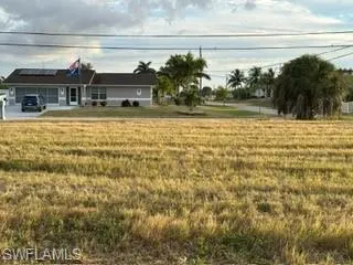 View of front of property featuring a front lawn and a rural view