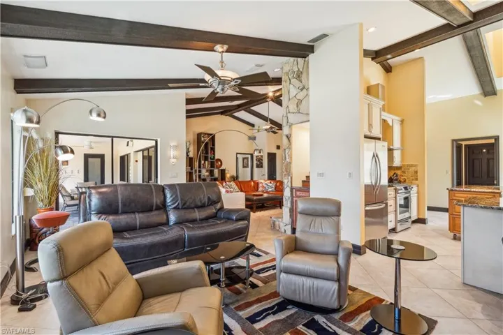 Living room with ceiling fan, lofted ceiling with beams Just off the kitchen ,