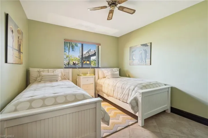 Guest Bedroom  ( first floor) # 1  - Tiled bedroom with ceiling fan.