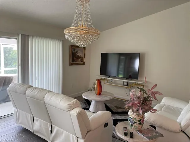 Living area featuring a chandelier and wood finish floors