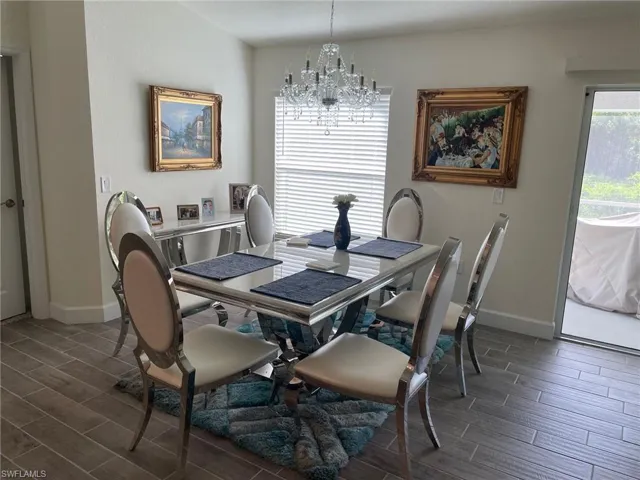 Dining area with wood finish floors and a chandelier