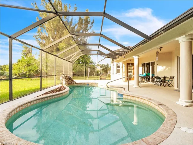 View of pool with a patio and a lanai