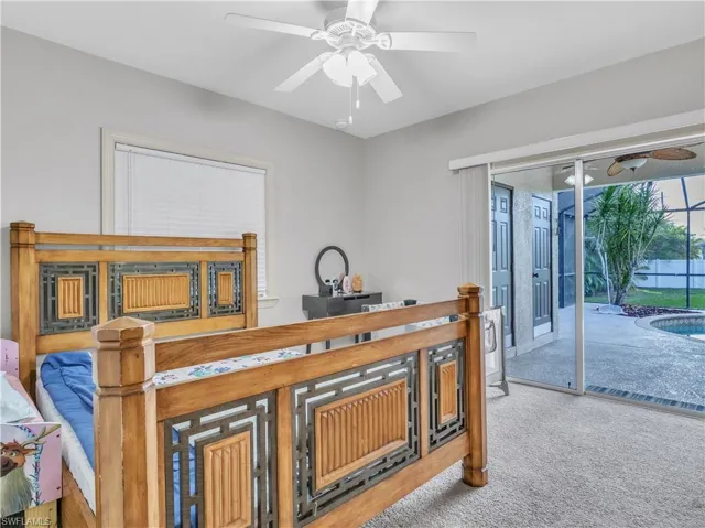Carpeted bedroom with access to exterior and ceiling fan