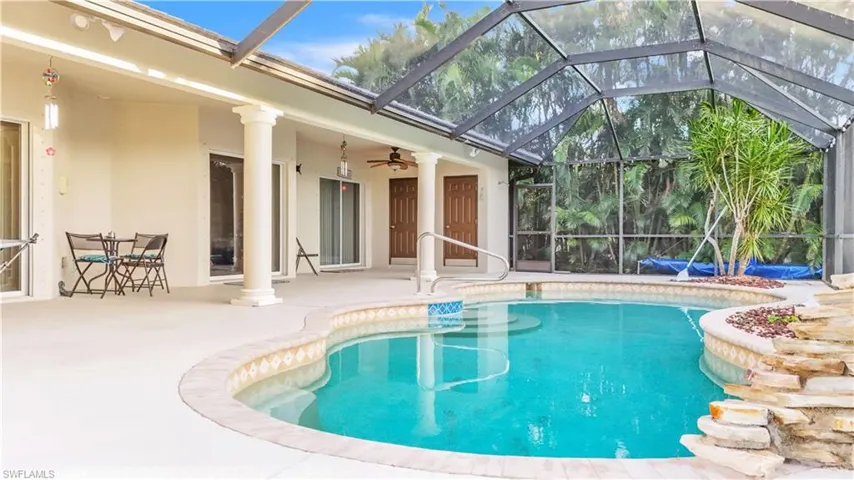 View of pool featuring ceiling fan, a lanai, and a patio
