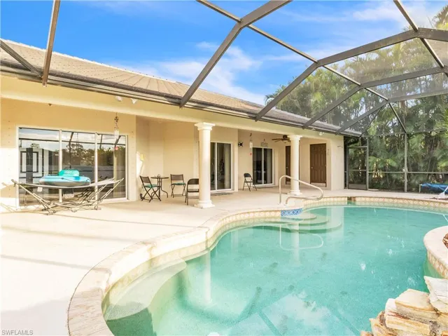 View of swimming pool featuring ceiling fan, a lanai, and a patio