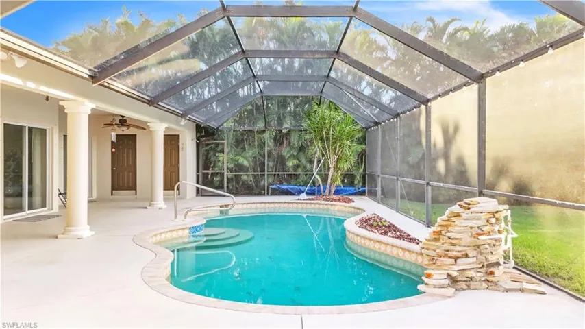 View of pool with a patio, ceiling fan, and a lanai
