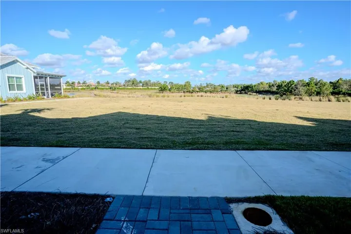 View of green lawn with a patio