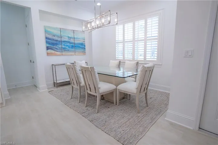 Dining area featuring light wood-type flooring and baseboards
