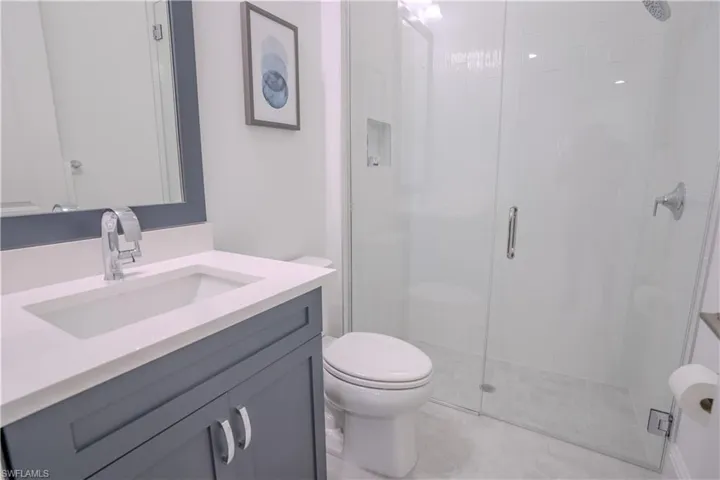 Full bath with vanity and a stall shower