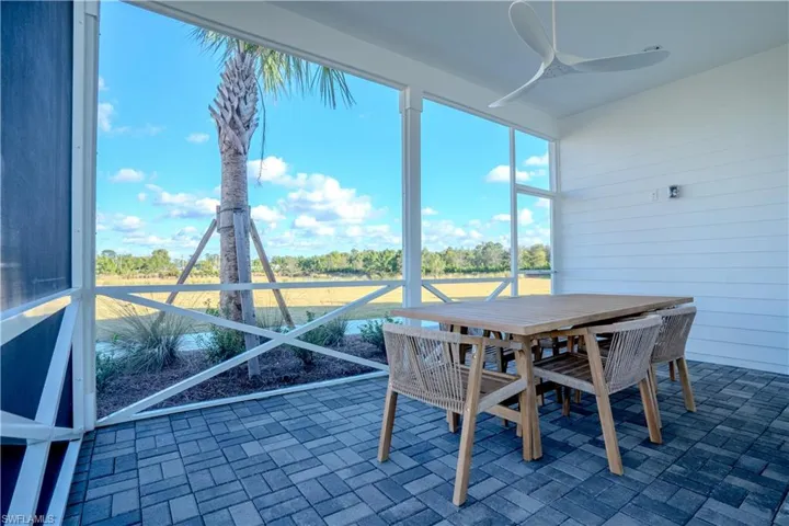 Sunroom featuring ceiling fan, outdoor dining area, and a patio area