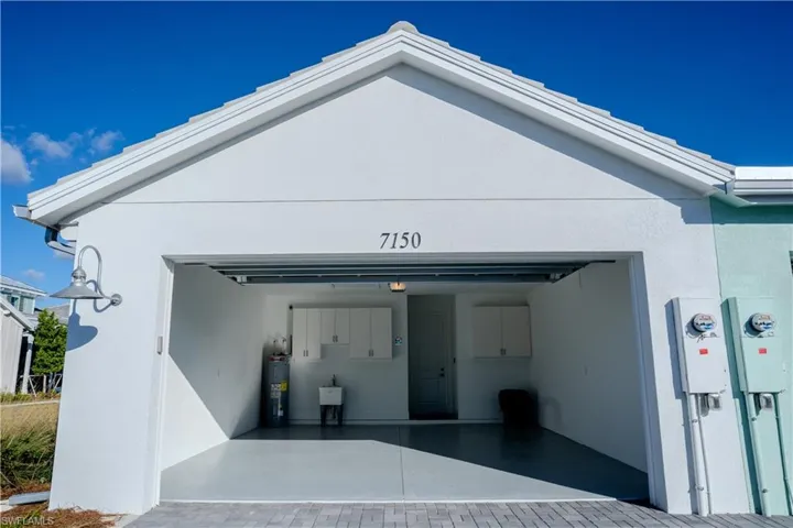 Garage with driveway and water heater