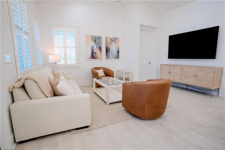 Living room featuring wood finished floors and vaulted ceiling