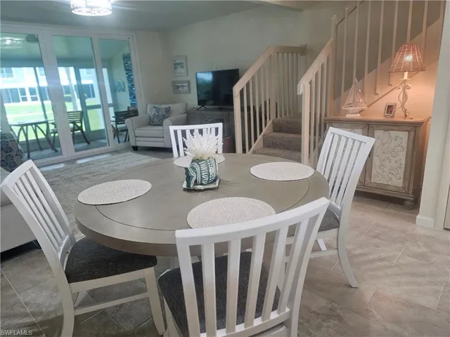 Dining room featuring stairway and stone tile flooring