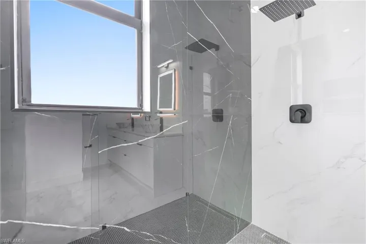 Bathroom featuring a marble finish shower and marble finish floor