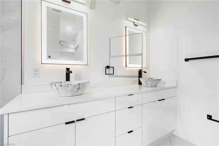 Bathroom featuring a sink and double vanity
