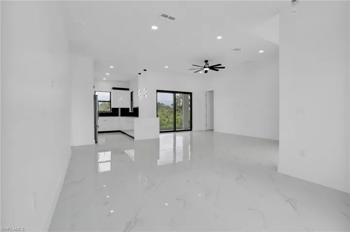 Empty room featuring light marble finish floors, recessed lighting, and a ceiling fan