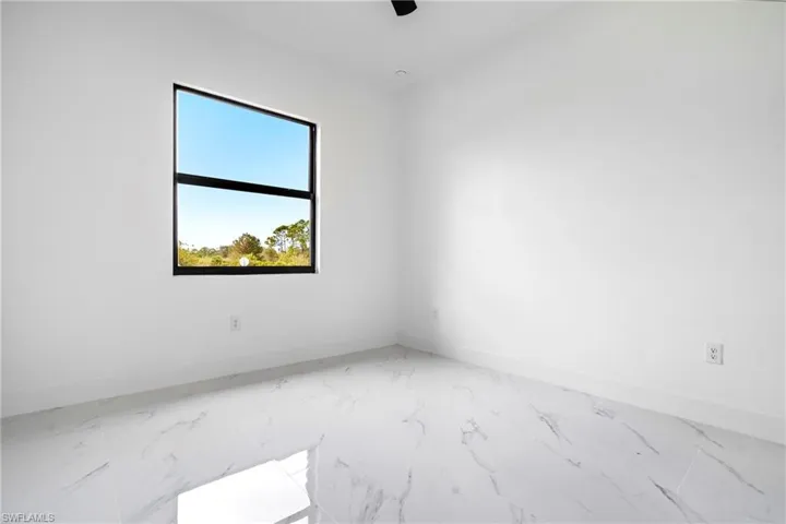 Unfurnished room with baseboards and marble finish floor