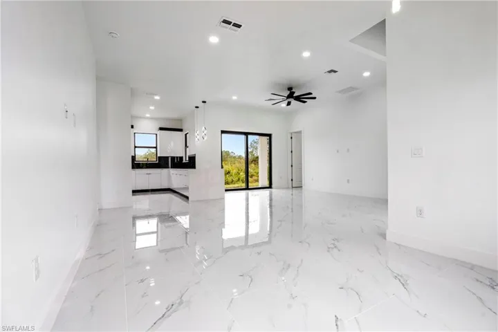 Unfurnished living room featuring recessed lighting, baseboards, visible vents, and marble finish floor