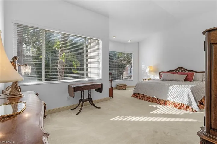 Bedroom with light colored carpet