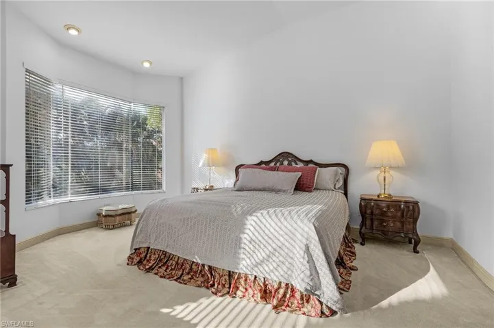 Carpeted bedroom with lofted ceiling