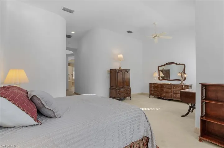 Bedroom featuring light carpet