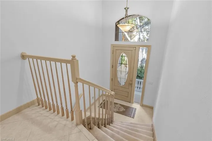 Tiled foyer featuring a high ceiling