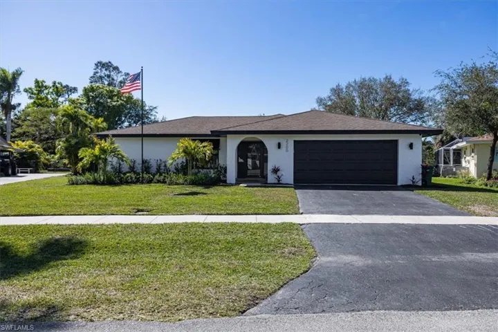 Ranch-style house with a garage and a front yard