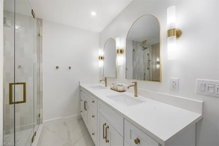 Bathroom with vanity and a shower with door