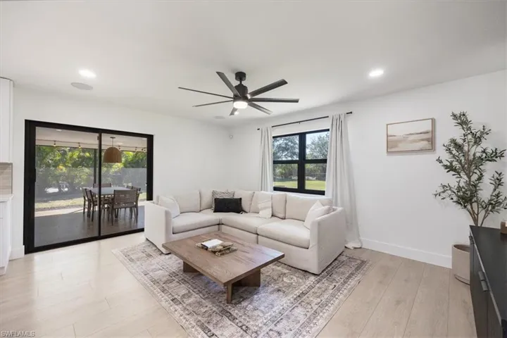 Living room featuring ceiling fan and light hardwood / wood-style flooring