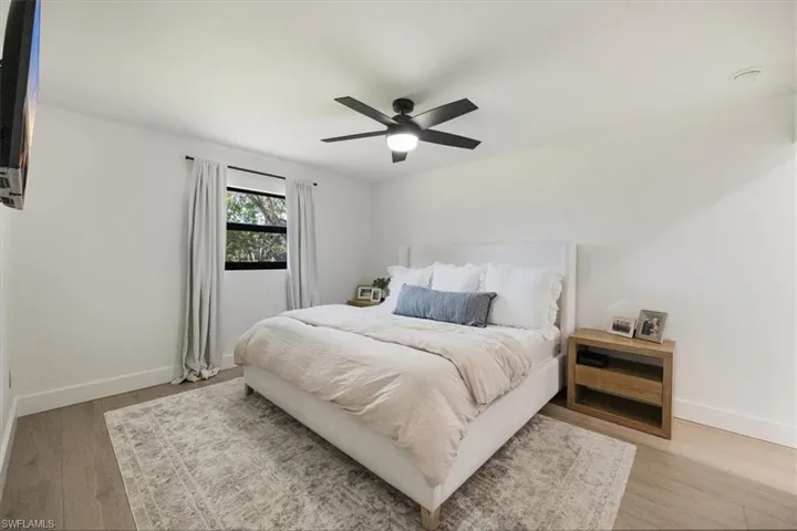 Bedroom featuring ceiling fan and light hardwood / wood-style floors