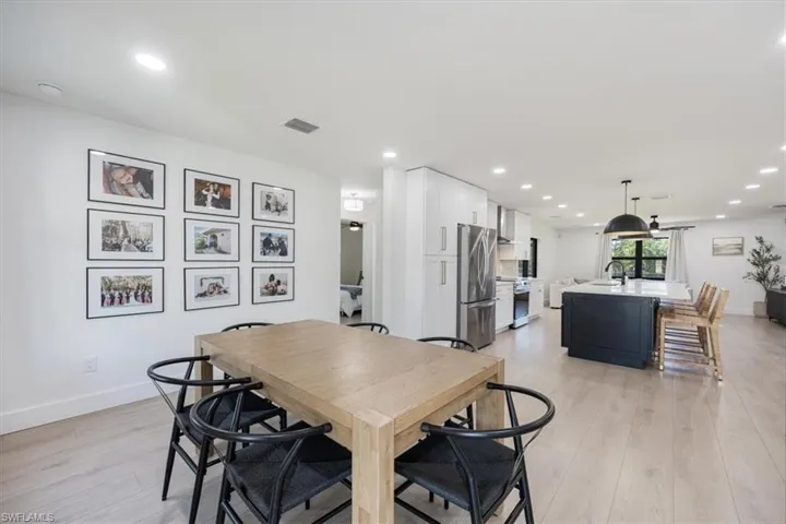 Dining space with sink and light hardwood / wood-style flooring