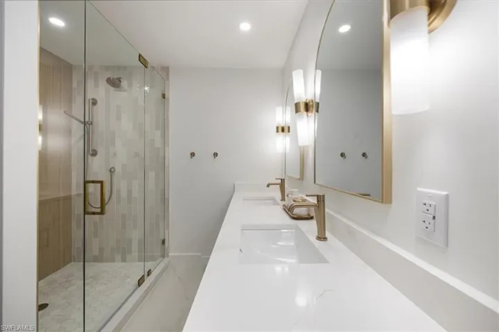 Bathroom featuring vanity and a shower with door
