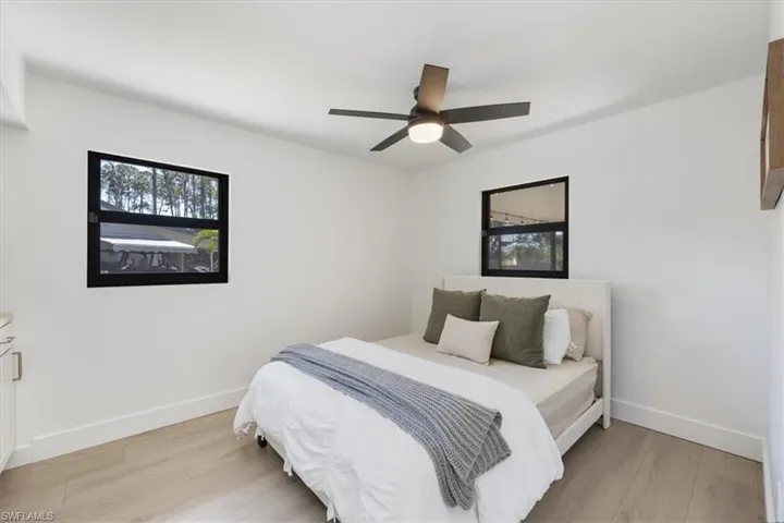 Bedroom with ceiling fan and wood-type flooring