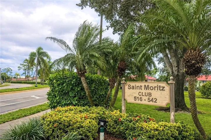 Community / neighborhood sign with a yard