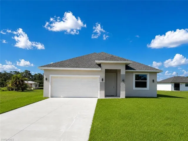 Contemporary single-story residence featuring a neutral stucco exterior and a dark shingle roof