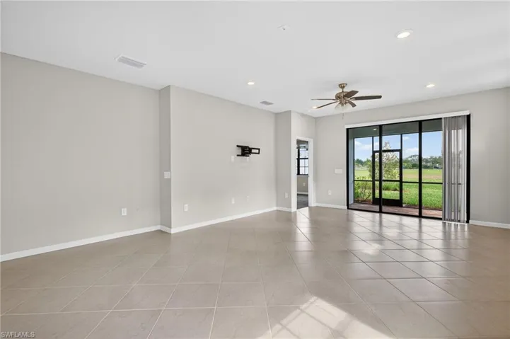 Dining room with a ceiling fan, recessed lighting, and light tile patterned flooring