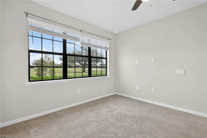 Primary Bedroom featuring a ceiling fan and carpet
