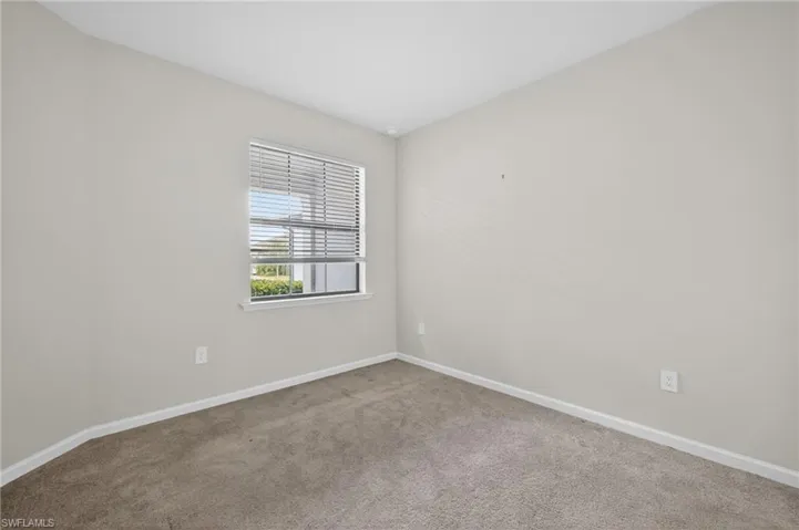 Unfurnished bedroom with baseboards and carpet floors