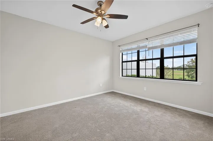 Primary Bedroom featuring baseboards and a ceiling fan