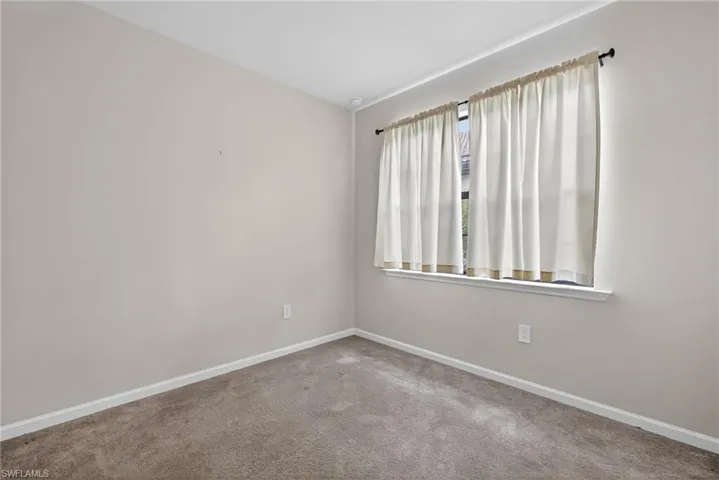 Carpeted bedroom featuring baseboards