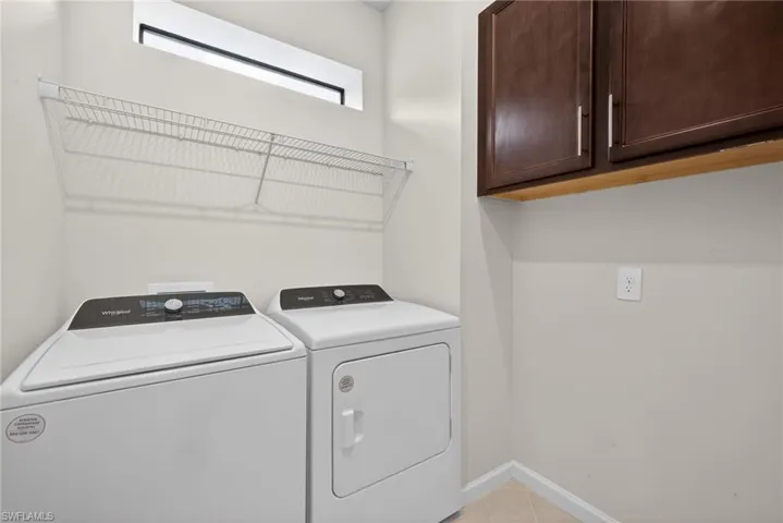 Laundry area with cabinet space and washing machine and dryer