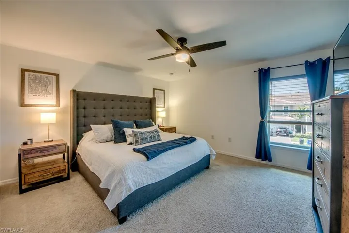 Bedroom featuring ceiling fan and carpet flooring
