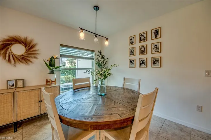 Dining space with light tile patterned floors